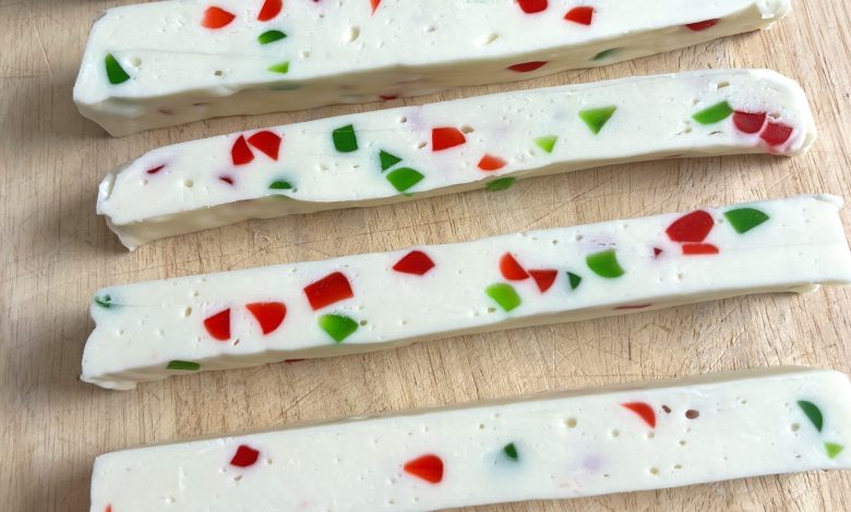 Festive no-bake white chocolate candy sticks filled with red and green jelly pieces, perfect for Christmas desserts and edible holiday gifts.