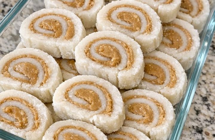 No-bake coconut peanut butter pinwheels arranged in a glass dish on a granite countertop