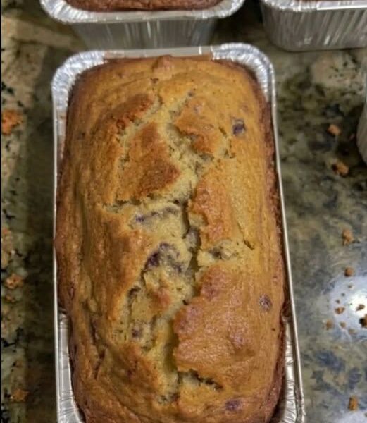 Homemade moist banana bread loaf with a golden brown top baked in a loaf pan.